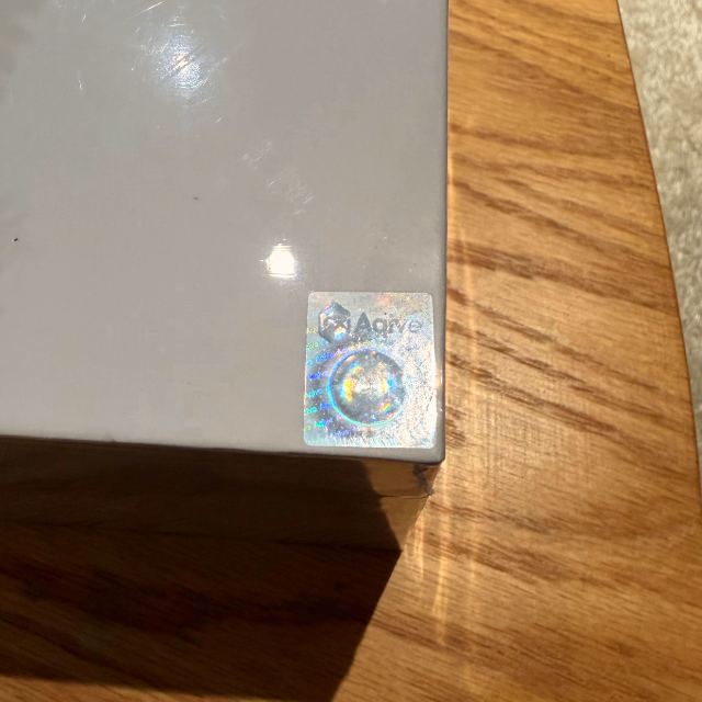Anti-counterfeit dynamic label on the corner of an Aqive box